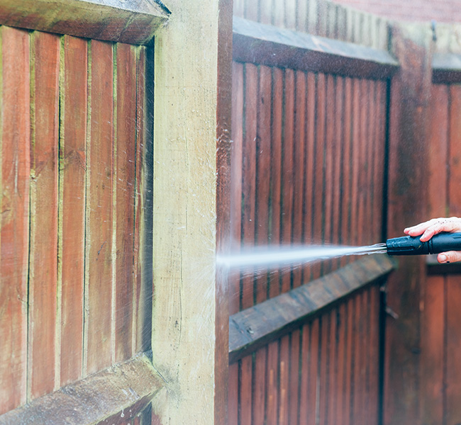 Washing a Fence with Professional Pressure Washer